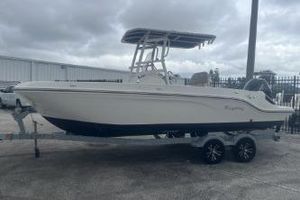 Bayliner Trophy T22CC 2023 Bayliner Trophy T22CC boat on trailer, parked outdoors under cloudy sky.