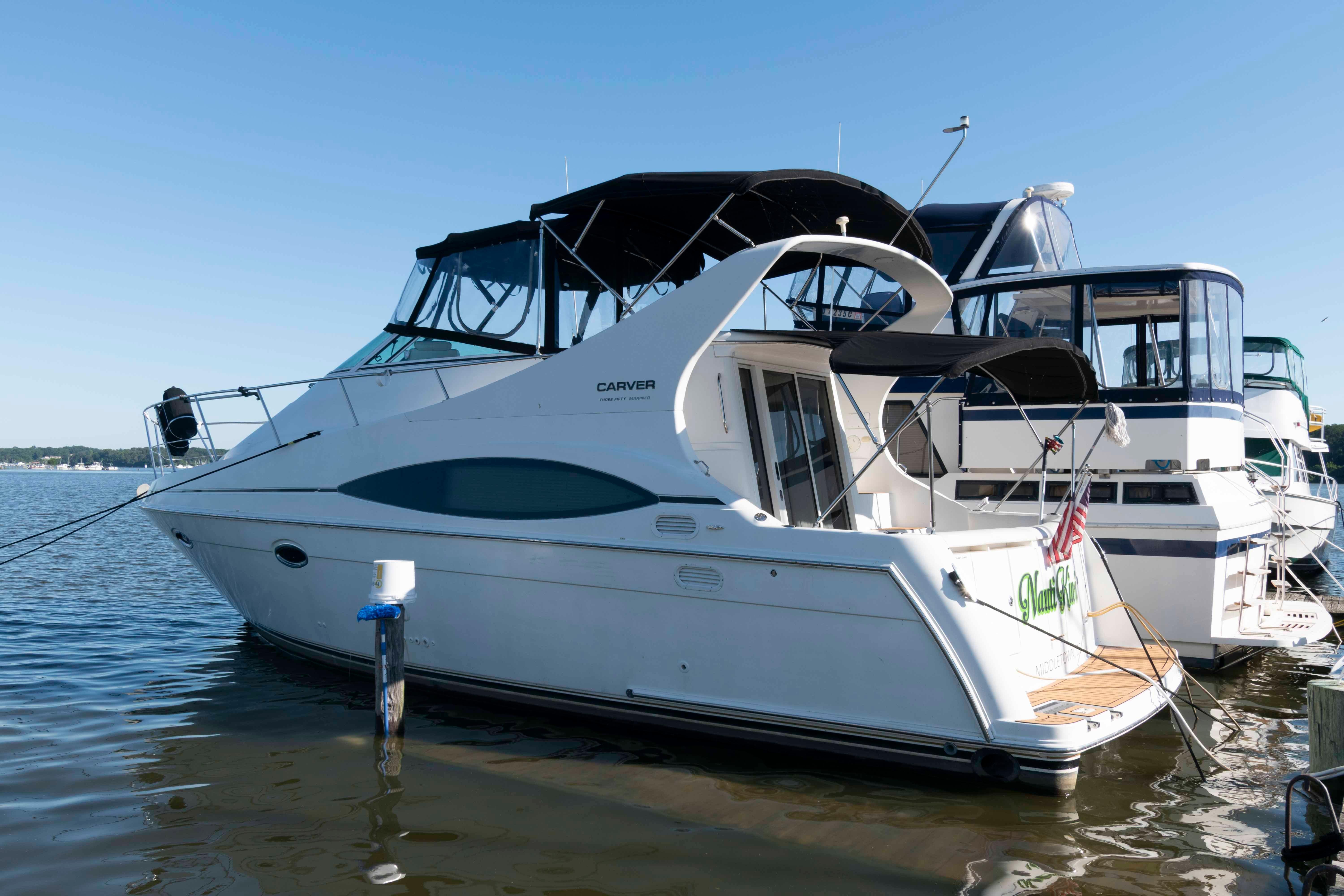 Carver 350 Mariner 2003 Carver 350 Mariner yacht docked at marina, clear blue sky background.