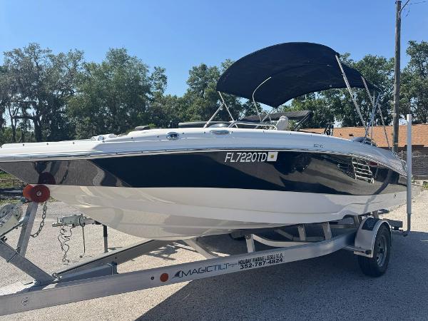 NauticStar 203SC Sport Deck 2022 NauticStar 203SC Sport Deck boat on trailer with canopy, parked outdoors.