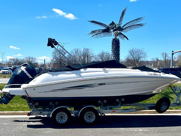 Sea Ray 220 Sundeck Outboard 2016 Sea Ray 220 Sundeck Outboard on trailer, parked outdoors under clear blue sky.