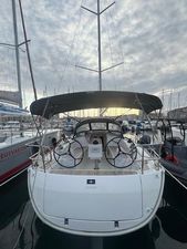Bavaria 34 Cruiser 2024 Bavaria 34 Cruiser yacht docked at marina, featuring dual steering wheels and spacious cockpit.