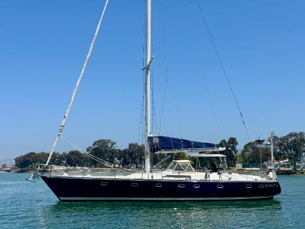 Tayana 55 1983 Tayana 55 sailboat on calm water, clear sky, side view.