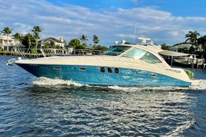 Sea Ray 48 Sundancer 2006 Sea Ray 48 Sundancer yacht cruising on a sunny day with palm trees in the background.