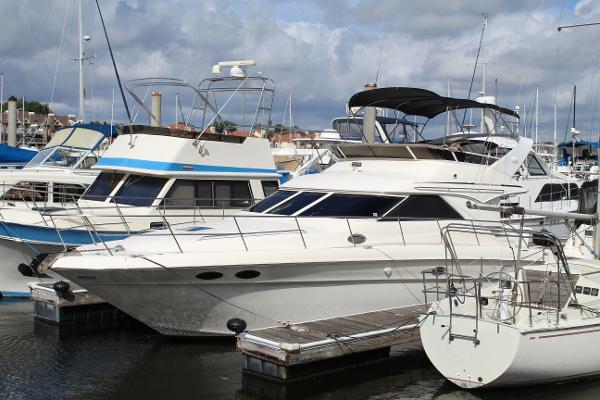 Sea Ray 400 Sedan Bridge 1997 Sea Ray 400 Sedan Bridge yacht docked at a marina, surrounded by other boats.