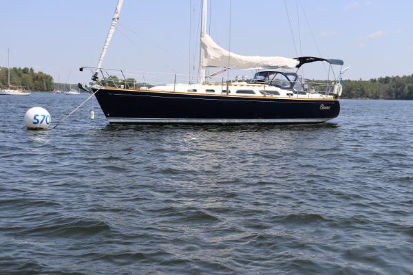Sabre 402 Sailboat Sabre 402, 2001 model, anchored on a calm lake with trees in the background.