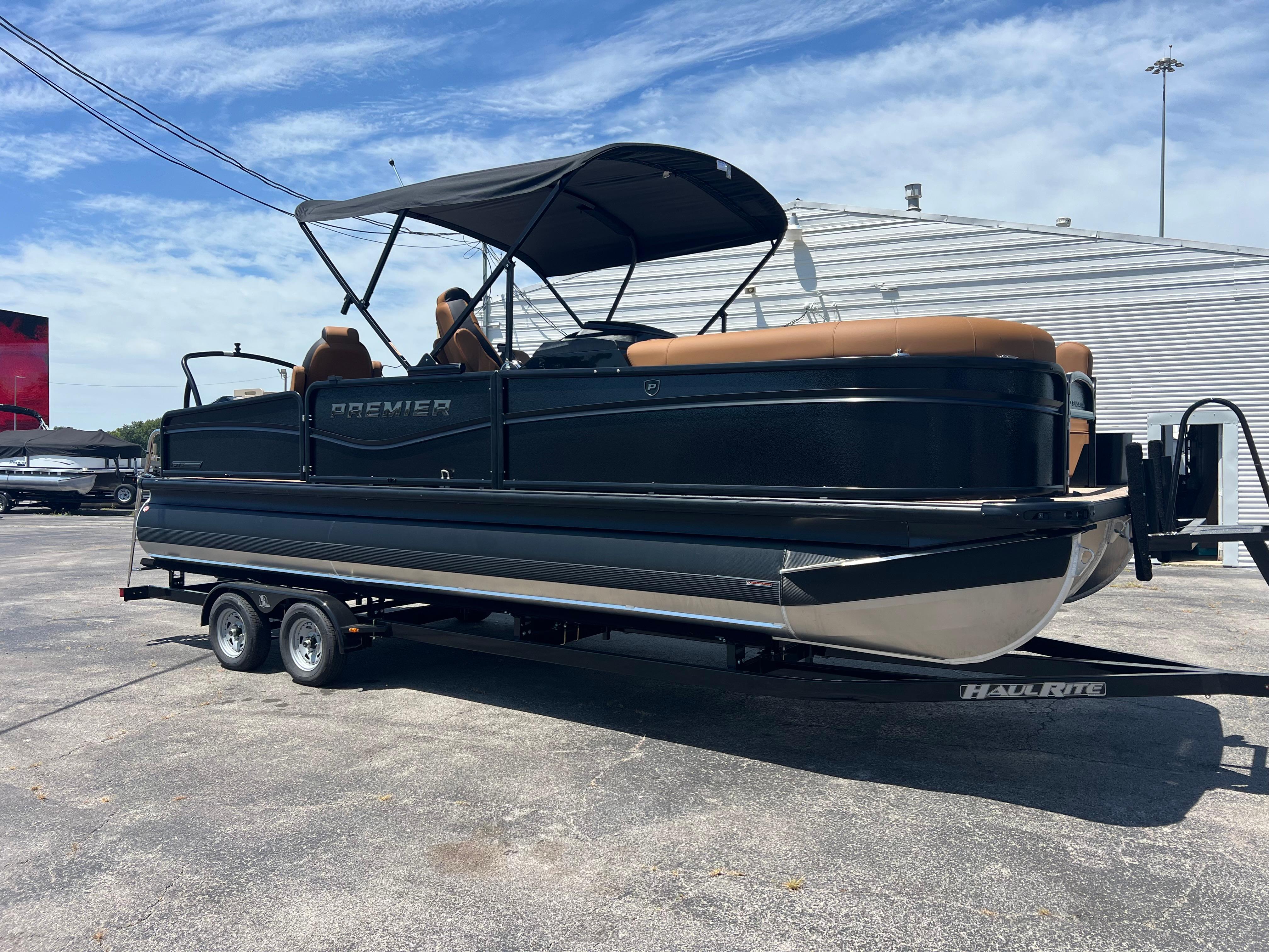 Premier 230 SunSation Angler 2026 Premier 230 SunSation Angler pontoon boat on trailer, outdoor display.