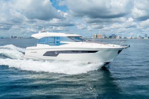Prestige 520S Luxurious 2018 Prestige 520S yacht cruising on open water under a cloudy sky.