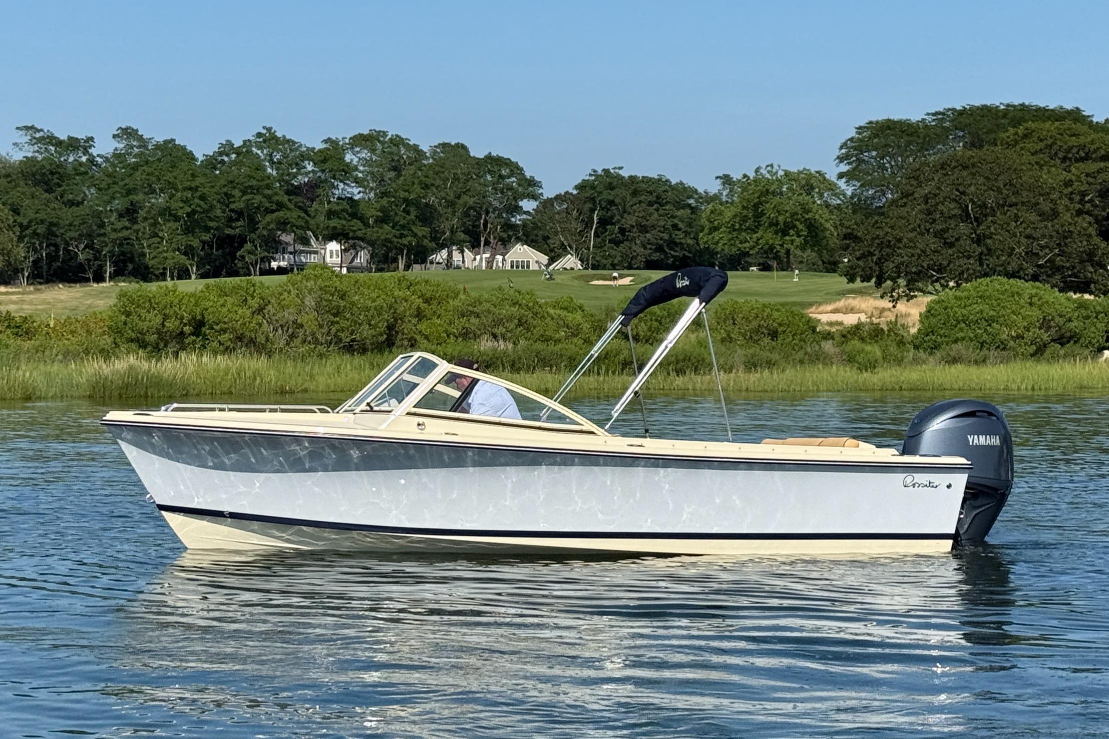 Rossiter R20 Day Boat 2026 Rossiter R20 Day Boat on calm water, surrounded by lush greenery.
