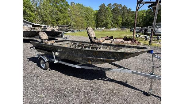 War Eagle 648LDV Sportsman 2025 War Eagle 648LDV Sportsman boat on trailer, camo design, parked outdoors.