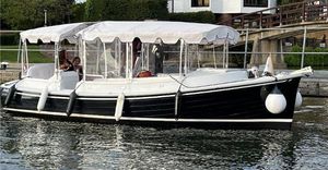 Duffy Cuddy Cabin 22 2022 Duffy Cuddy Cabin 22 boat docked, featuring a canopy and fenders, on calm water.