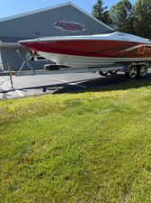 Baja 26 Outlaw 2007 Baja 26 Outlaw boat on trailer outside marine supply store.