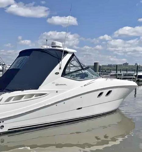 Sea Ray 310 Sundancer 2007 Sea Ray 310 Sundancer boat docked on a sunny day with blue skies.
