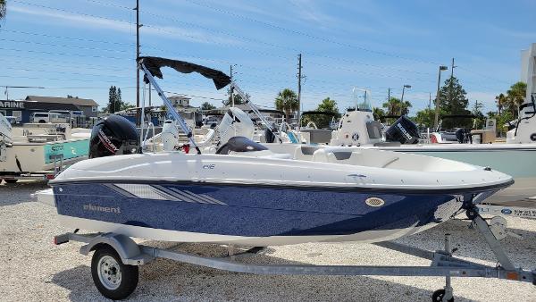 Bayliner Element E16 2025 Bayliner Element E16 boat on trailer, displayed outdoors under clear sky.
