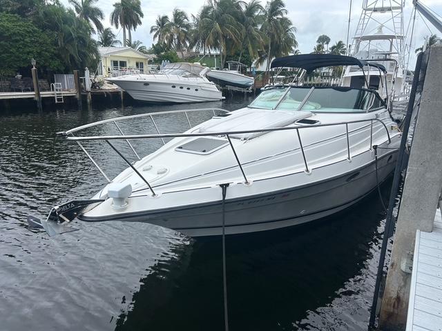 Doral 300 SC 1998 Doral 300 SC boat docked in a marina with palm trees in the background.