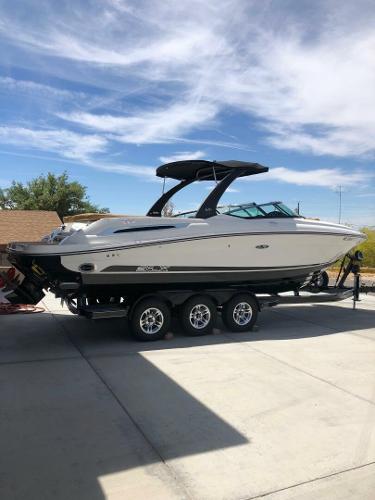 Sea Ray 250 SLX 2016 Sea Ray 250 SLX boat on trailer, parked outdoors under a clear sky.