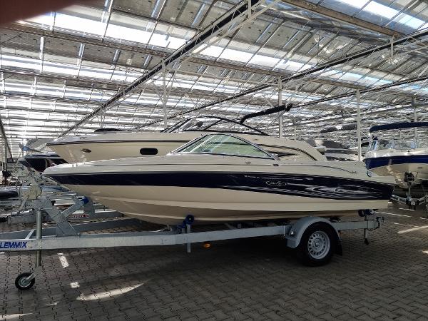 Sea Ray 180 Sport 2005 Sea Ray 180 Sport boat on trailer in indoor showroom.