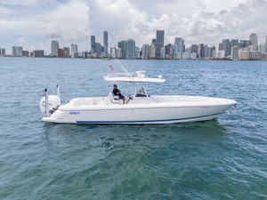 Intrepid 345 Nomad FE 2021 Intrepid 345 Nomad FE boat cruising near city skyline on a sunny day.