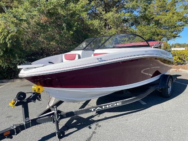 Tahoe 185 S 2024 Tahoe 185 S boat on trailer, red and white, parked outdoors.