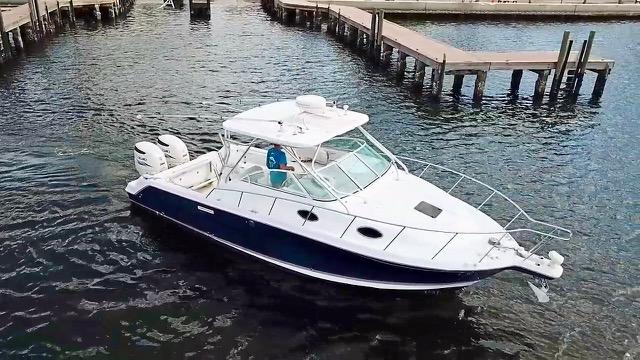 Wellcraft 290 Coastal 2005 Wellcraft 290 Coastal boat docked in marina, featuring sleek design and dual engines.