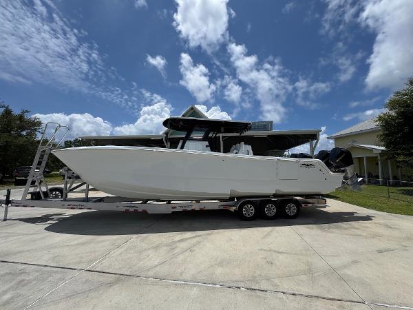 Invincible 36 Catamaran 2026 Invincible 36 Catamaran on trailer under a partly cloudy sky.