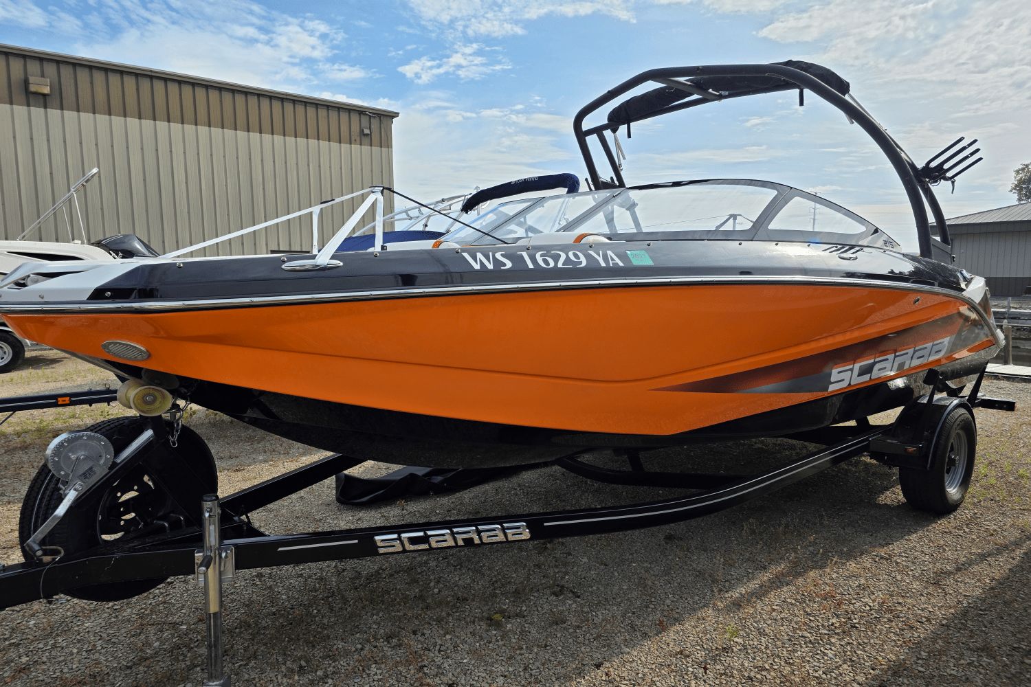 Scarab 215 HO Impulse 2016 Scarab 215 HO Impulse boat in vibrant orange on a trailer.