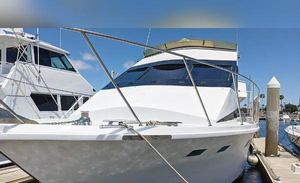 Custom custom Custom 1989 yacht docked at marina under clear blue sky.