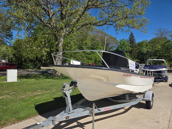 Boston Whaler 190 Montauk 2010 Boston Whaler 190 Montauk boat on trailer, parked outdoors on a sunny day.