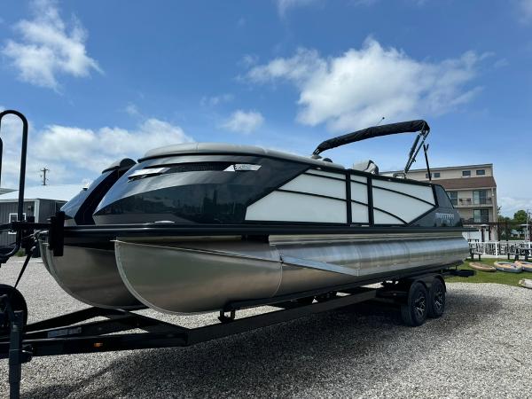 Montara naxos 2024 Montara Naxos pontoon boat on trailer under blue sky.