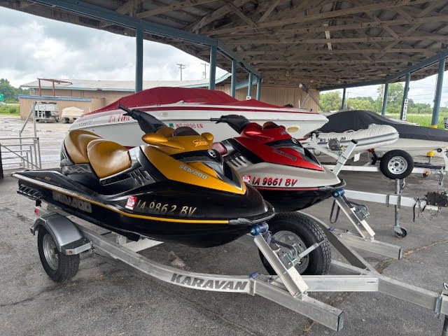 Sea-Doo RXT 2006 Sea-Doo RXT jet ski on trailer under shelter, alongside other watercraft.
