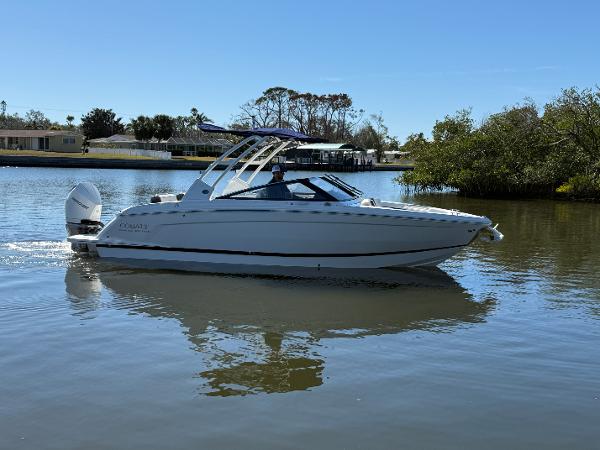 Cobalt R6 Outboard 2025 Cobalt R6 Outboard boat cruising on a calm lake under clear blue skies.