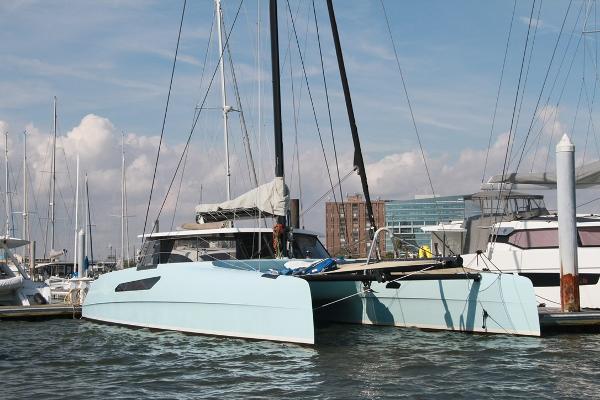 Gunboat 55 2017 Gunboat 55 catamaran docked at marina, clear sky, modern design.