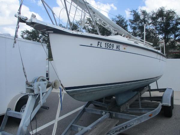 Com-Pac 23 1993 Com-Pac 23 sailboat on trailer, parked outdoors.