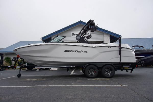 MasterCraft NXT23 2025 MasterCraft NXT23 boat on trailer in front of Dyer Marine building.