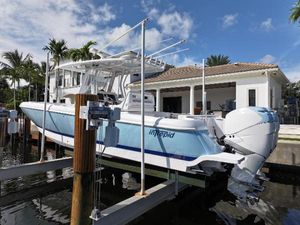 Intrepid 327 2017 Intrepid 327 boat docked near a waterfront home.