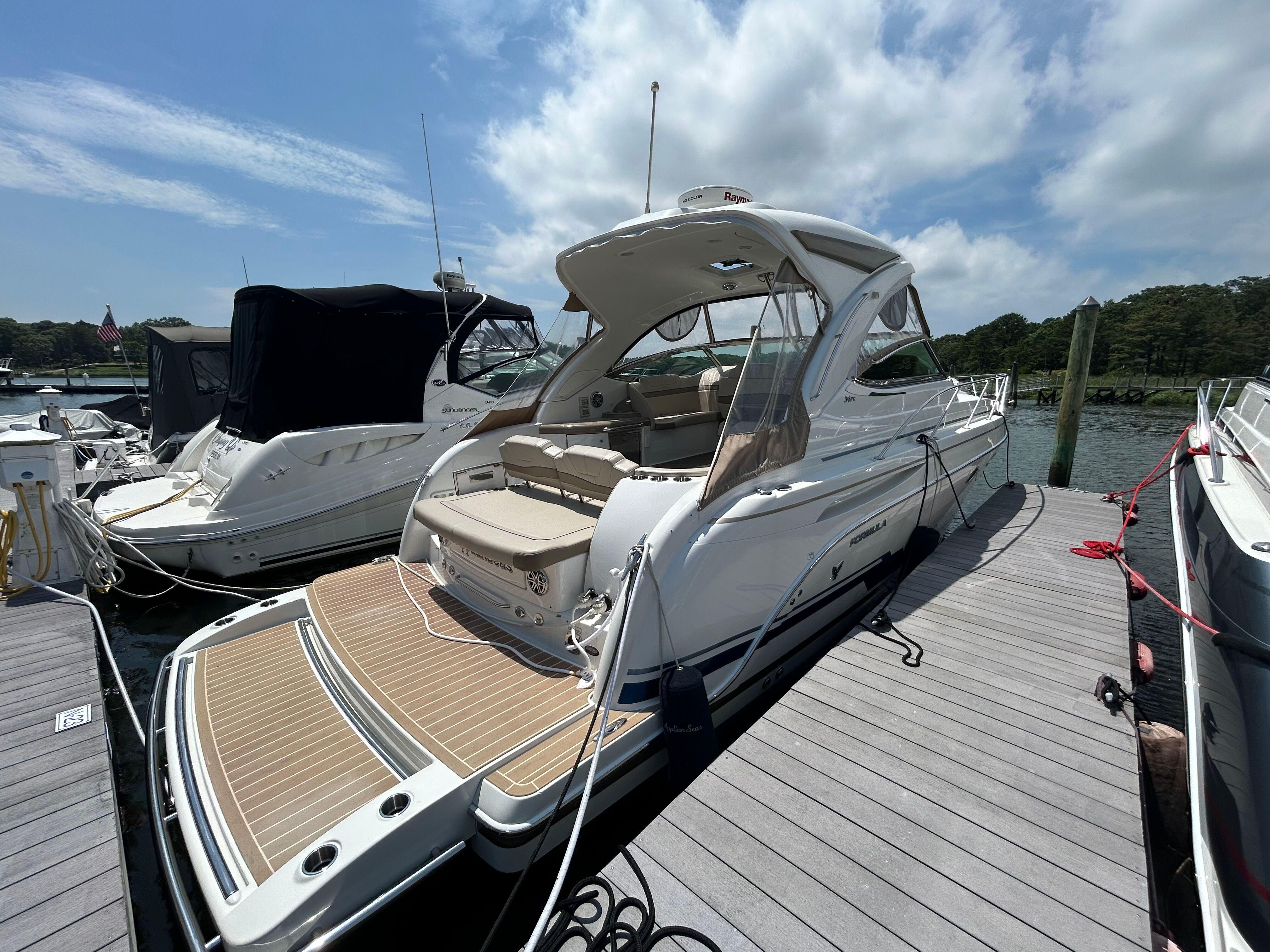 Formula 34 Performance Cruiser 2021 Formula 34 Performance Cruiser docked at marina under blue sky.