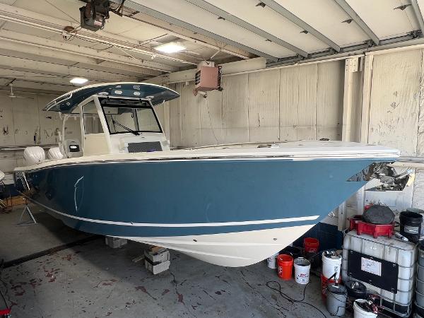 Cobia 350 Center Console 2025 Cobia 350 Center Console boat in a garage, blue hull, white interior.