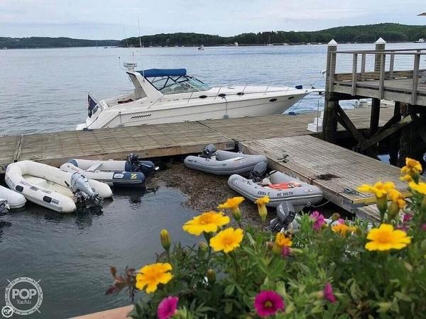 Sea Ray 370 Express Cruiser 1994 Sea Ray 370 Express Cruiser docked by a wooden pier with colorful flowers.