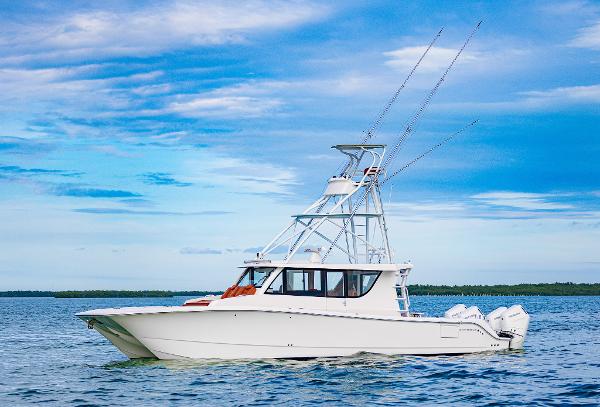 Invincible 46 Pilothouse 2023 Invincible 46 Pilothouse boat on calm water under blue sky.