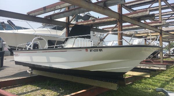 Boston Whaler 210 Montauk 2015 Boston Whaler 210 Montauk boat on a trailer in a marina setting.