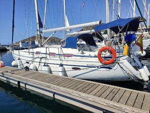 Bavaria 39 Cruiser Bavaria 39 Cruiser 2006 sailboat docked at marina with blue canopy and lifebuoy.