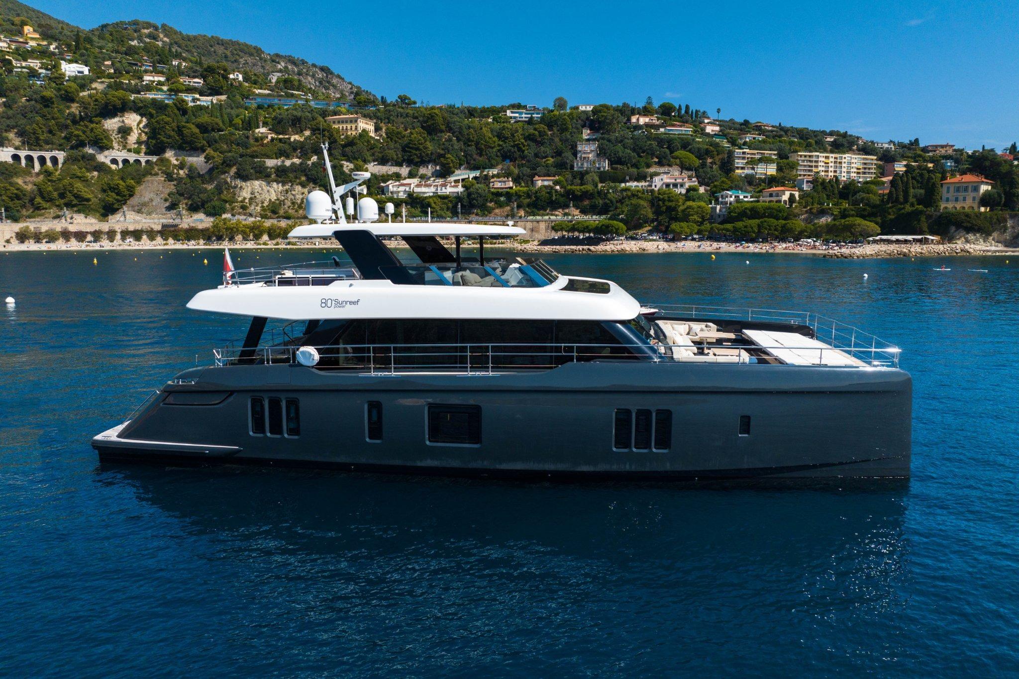 Sunreef 80 Sunreef Power MANTA Luxurious 2022 Sunreef 80 Power MANTA yacht cruising near scenic coastline.