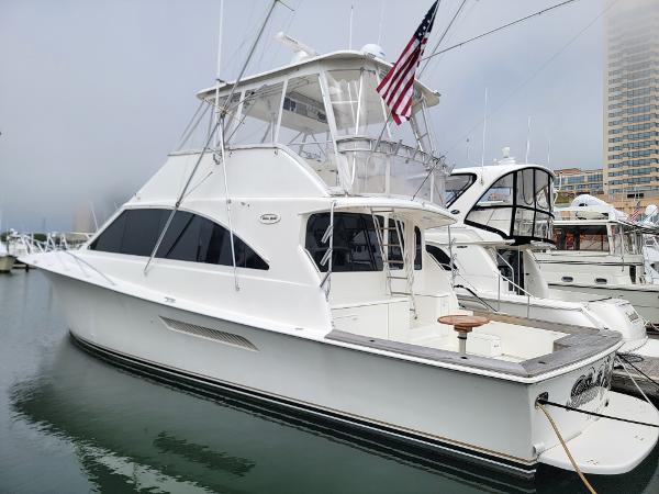 Ocean Yachts 56 Super Sport 2001 Ocean Yachts 56 Super Sport docked at marina, featuring flybridge and American flag.