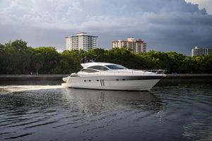 Pershing 62' 2007 Pershing 62' yacht cruising on calm waters near urban skyline.