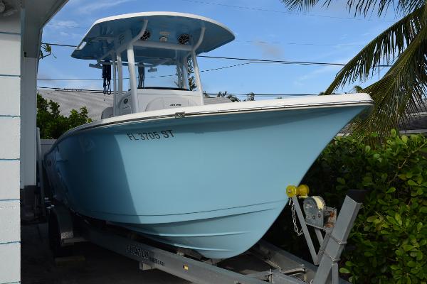 Sea Pro 239 Center Console 2020 Sea Pro 239 Center Console boat on trailer, light blue hull, parked outdoors.
