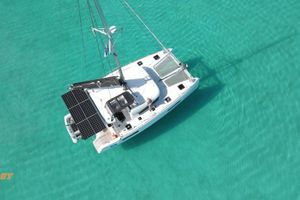 Lagoon 40 Aerial view of 2021 Lagoon 40 catamaran on clear turquoise water.
