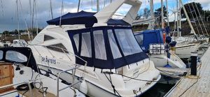 Sealine F34 2007 Sealine F34 yacht docked at marina with blue canopy.