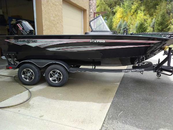 Ranger VX1788 WT 2024 Ranger VX1788 WT boat on trailer, parked outside a garage.