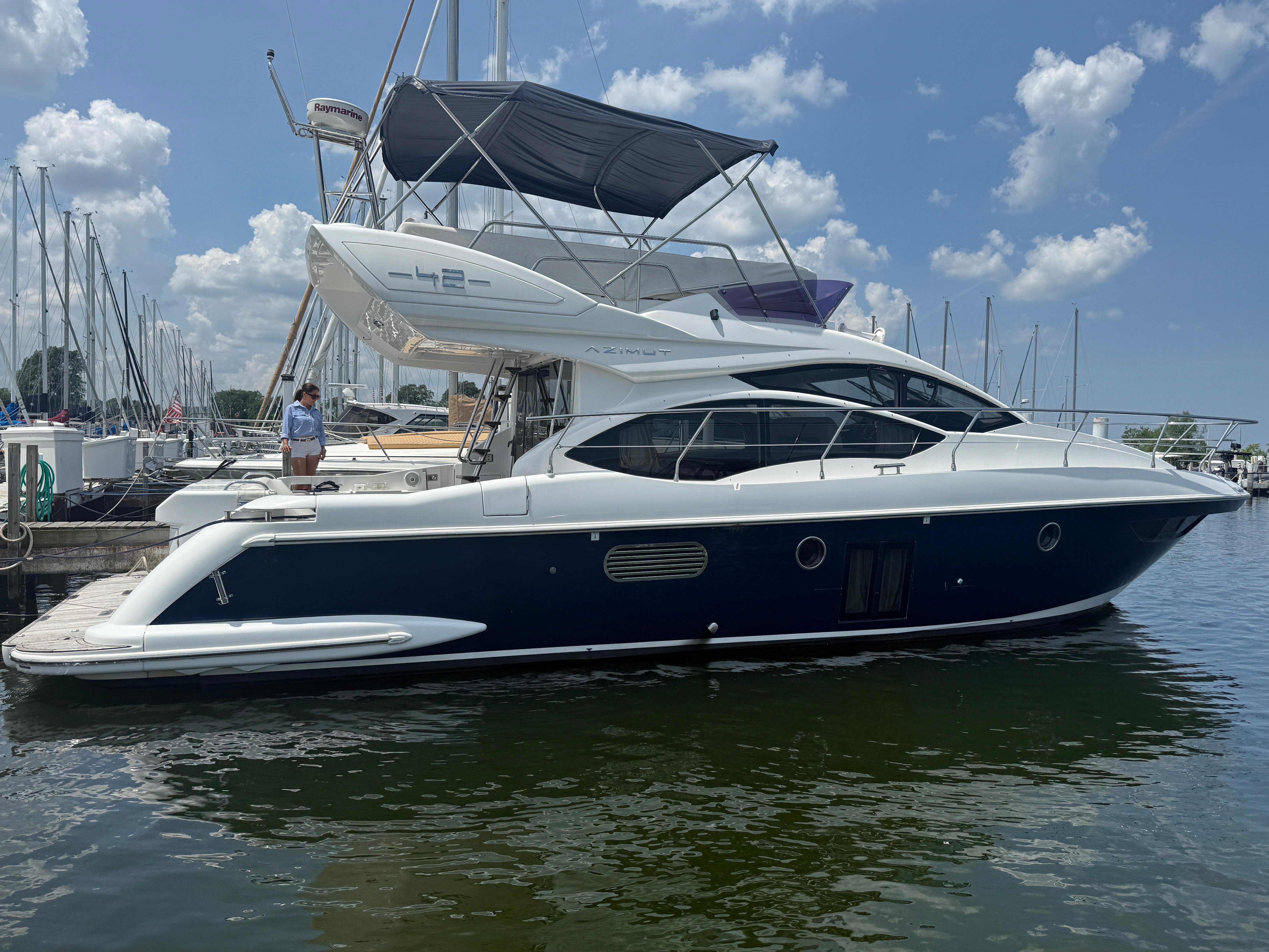 Azimut 42 Fly 2018 Azimut 42 Fly yacht docked at marina under blue sky.