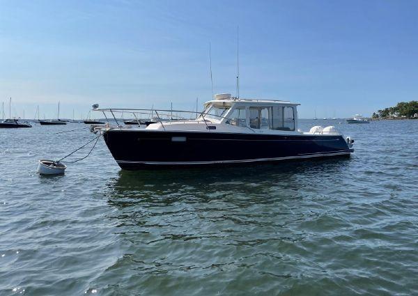 MJM 35z 2020 MJM 35z boat anchored on calm water under clear blue sky.