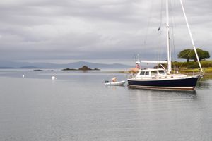 Bruckmann 50 MKII Sailboat Bruckmann 50 MKII (2006) anchored near scenic coastline under cloudy skies.